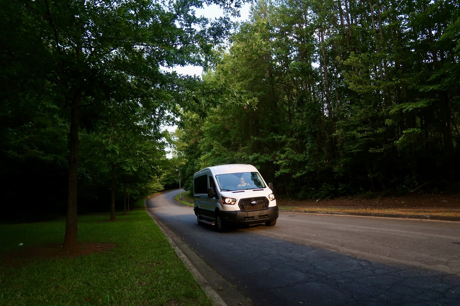 A Doctor Ride NEMT van driving a tree lined road in Charlotte